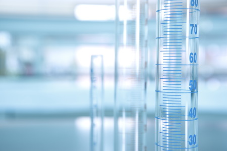 volume measuring cylinder in science laboratory background