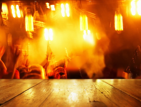 top of table wood background with blur orange light of party in bar  backgroundの写真素材