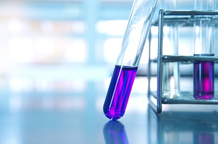 purple glass test tube and metal rack  in medical experiment science with light laboratory backgroundの写真素材