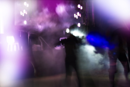 people dance on party in club or bar at night with blue and purple light blur backgroundの写真素材