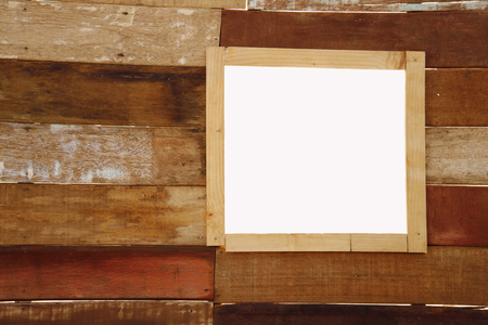rectangular frame window on retro brown wood home wall backgroundの写真素材