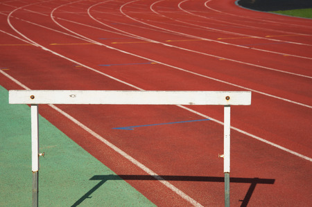 single white wood training hurdle race on red running in sport stadium track backgroundの写真素材