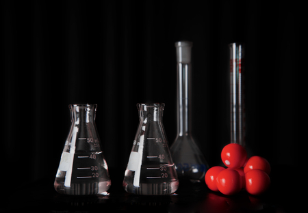 medical research science glass flasks with water and red chemical molecular structure still life...