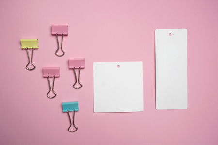pastel colorful pink yellow green metal clip with store label white note paper for business or education sweet backgroundの写真素材