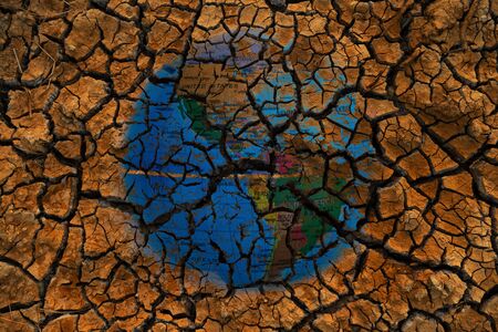 blue global map double exposure on dry or drought red soil land in global warming or climate change environmental issue conceptの写真素材