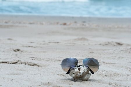 summer sunglasses on the beach with blue seawater nature travel backgroundの写真素材