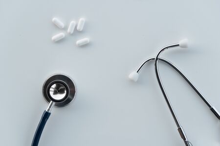 metal stethoscope for disease medical doctor diagnosis and white drug pill for therapy background    の写真素材