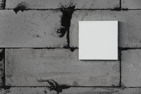 single empty white canvas frame on grunge grey concrete wall backgroundの写真素材