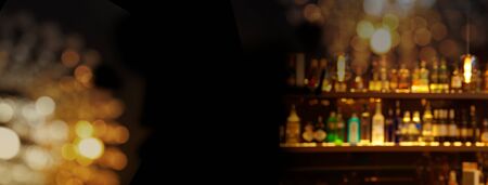 party glowing blur light with alcohol drink bottle at club pub or bar in dark party night web black banner backgroundの写真素材