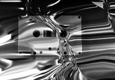 monochrome retro cassette tape music listening in vintage style with silver metal effect backgroundの写真素材