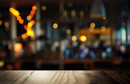 top of black table with blur dark bar or cafe at night abstract background