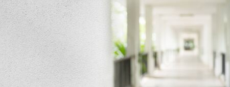 white cement texture with blur perspective of corridor with natural sunlight architecture banner backgroundの写真素材