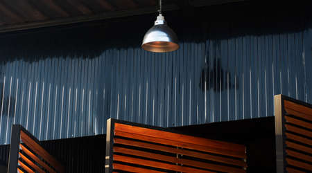 black metal wall with lamp and blind window industrial loft architecture backgroundの写真素材