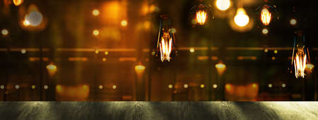 top of wood table with blur bar or pub with vintage lamp in dark night party light city interior...