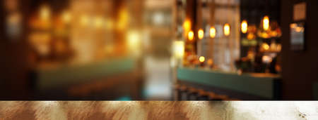 top of wood table or counter with blur light in pub or bar night party banner background