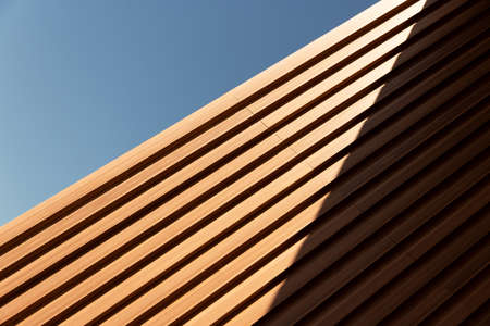 line of yellow brown wood in detail building and blue sky abstract architecture background