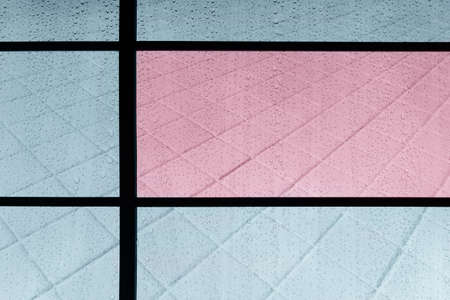rain water drop on mirror with blue pink modern rectangular tile wall architecture background