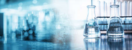 water in two glass flask and test tube in soft information and blue light medical science laboratory banner backgroundの写真素材