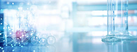glass cylinder and test tube science equipment in blue information research lab backgroundの写真素材