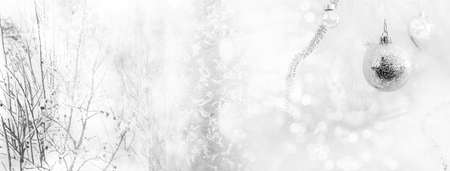 white single silver Christmas ball and glowing snow flake with bush tree light bokeh party banner backgroundの写真素材