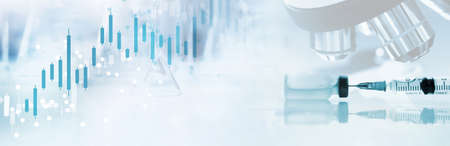 vaccine syringe and microscope in connection soft white blue light medical science lab and research data information graph banner backgroundの写真素材
