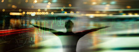 black silhouette of man resting arm with stock market business graph with city light in freedom financial concept banner backgroundの写真素材