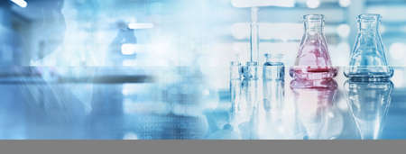 scientist with mask shadow with glass flask and beaker in medical health science of blue technology banner backgroundの写真素材