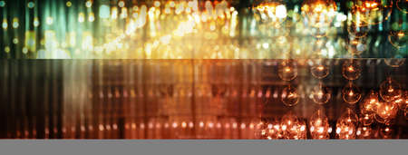 blur orange lamp abstract light at night in bar or pub backgroundの写真素材