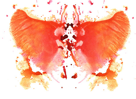 orange watercolor symmetrical Rorschach blot on a white backgroundの写真素材