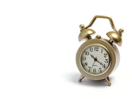 Gold miniature alarm clock isolated on white backgroundの写真素材