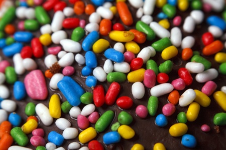 multicoloured truffle candy on dark chocolate, macro shootの写真素材