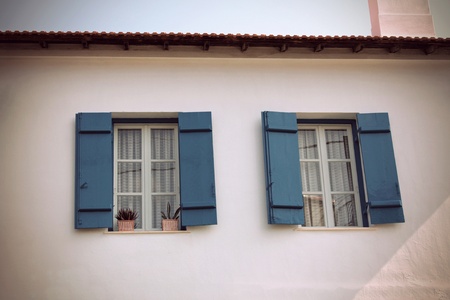 Two windows with blue wooden shutters, retro / vintage styleのeditorial素材