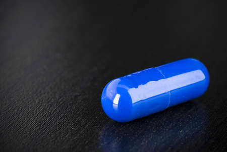 Some blue mediction on a black surfaceの写真素材