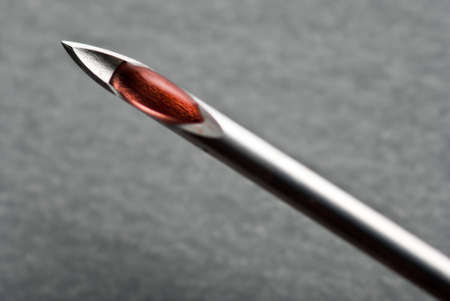 The Sharp point from a medical injection needle over grayの写真素材