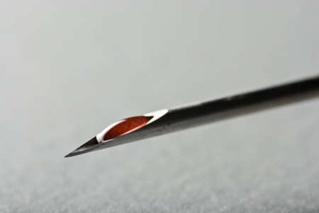 The Sharp point from a medical injection needle over grayの写真素材