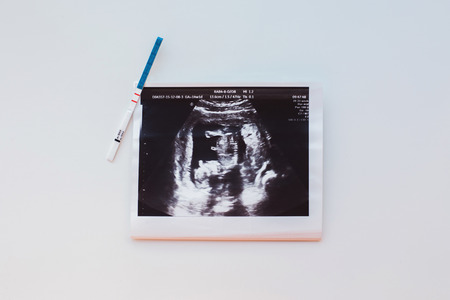 Pregnancy test and the picture on the table