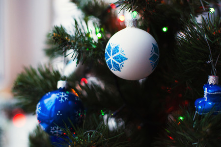 Christmas ball hanging on a green Christmas treeの写真素材