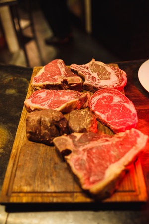 Juicy and appetizing steaks on the grill. The cooking process and a great picture for the restaurant.の写真素材