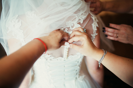 Beautiful bride close up in white dress. Dress with laceの写真素材
