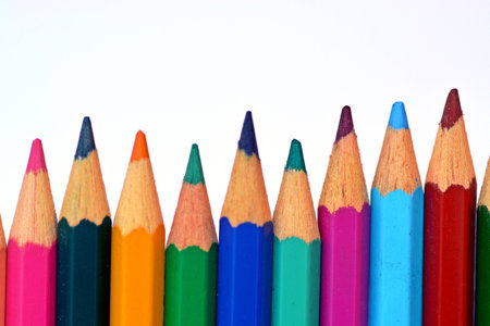 Colored crayons in row in front of a white backgroundの写真素材