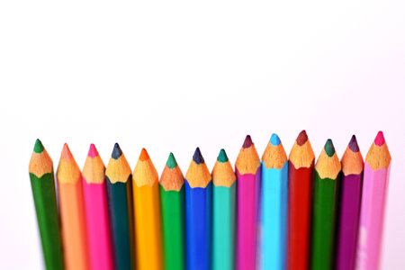 Colored crayons in row in front of a white backgroundの写真素材