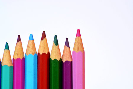 Colored crayons in row in front of a white backgroundの写真素材