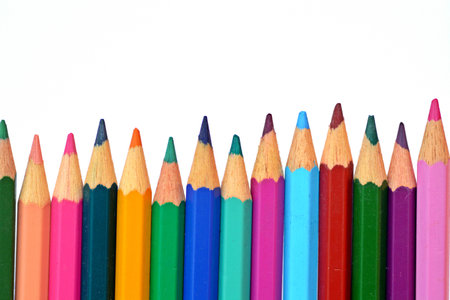 Colored crayons in row in front of a white backgroundの写真素材