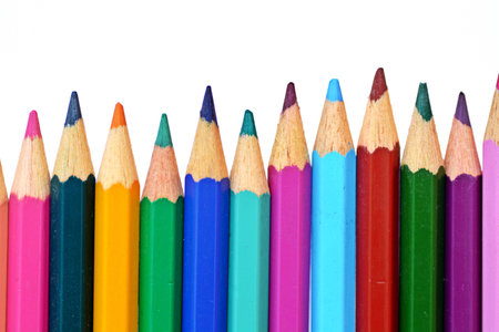 Colored crayons in row in front of a white backgroundの写真素材