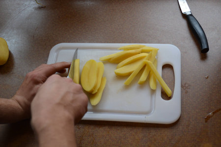 Cut potatoes into friesの写真素材