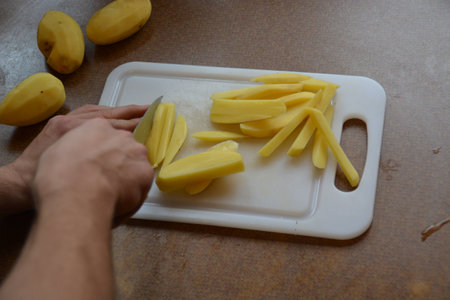 Cut potatoes into friesの写真素材