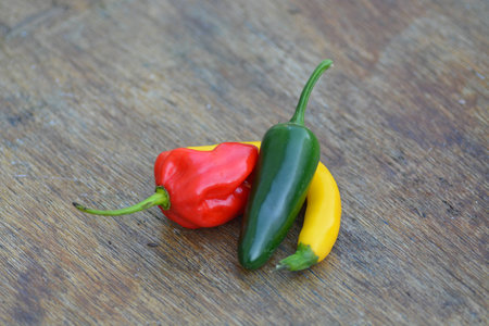 Different peppers on a wooden tableの写真素材