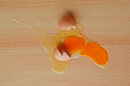 broken egg on wooden tableの写真素材
