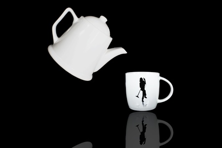 white teapot and cup with black color backgroundの写真素材