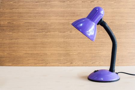 Backgroung image of violet desk lamp on the wood floorの写真素材